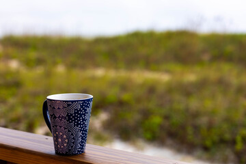 Photo of a coffee cup in the morning at the beach on a summer vacation holiday