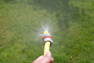 Focus on water spraying from a water hose.
