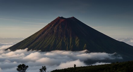 Fototapeta premium Majestic Volcano Mountain Peak Surrounded by Clouds During Daytime