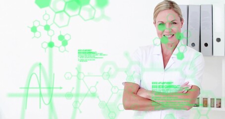 Standing woman wearing lab coat in lab, showing green overlays, binders, vials, copy space