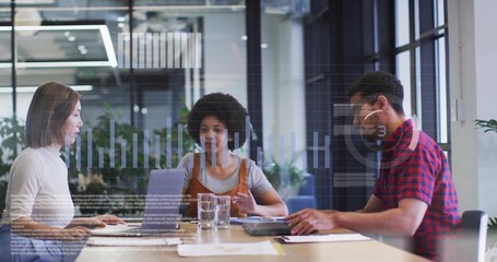 Conducting data analysis three colleagues at wooden table in modern office, with laptops and charts