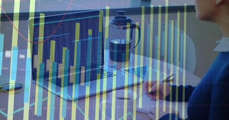 Writing woman in sweater noting in spiral notebook at office, with laptop, data overlay, copy space