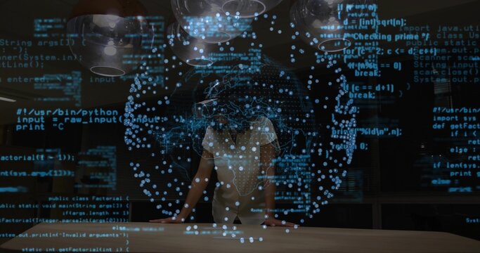 Woman wearing blouse and pants manipulating holographic data sphere above table in lab, with code