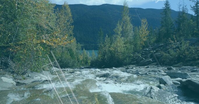 Fototapeta Rushing whitewater rapids cascading over river rocks in mountain stream, with lake and forest