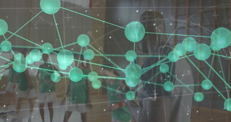 Standing athletes in green jerseys with rackets and coach gesturing on court, showing data overlay