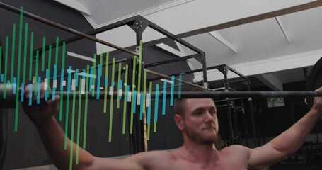 Lifting shirtless man pressing barbell overhead in gym weight area with pullup rig and colored bars