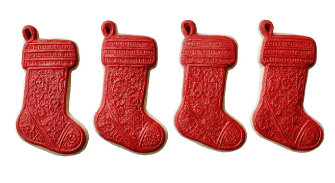Four Christmas stocking cookies, red and cream colored, on a black background - Powered by Adobe
