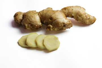 Fresh ginger rhizome and ginger slices on a white background ready to be used as a cooking spice, warming herbal drink, Rich in health benefits and Ideal for culinary and lifestyle content