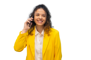Professional woman smiling, talking on smartphone, expressing confidence with bright, welcoming demeanor against clean white background