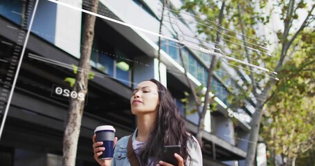 Commuter woman walking, sipping coffee while swiping smartphone, activating AR overlays - Powered by Adobe