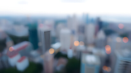 Fototapeta premium A blurred cityscape with skyscrapers and soft lights, creating a dreamy urban atmosphere.