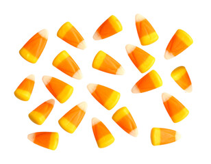 Lots of gummy corn candy for Halloween isolated on white background. Cut out image, chewy gummy orange candies.