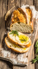 Freshly baked artisan loaf sliced and drizzled with olive oil, rosemary sprigs