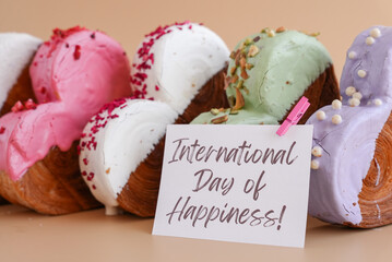 International day of happiness saying caption on greeting card Delightful and vibrant heartshaped pastry croissant treat, beautifully topped with colorful frosting galore. Copy space. Food
