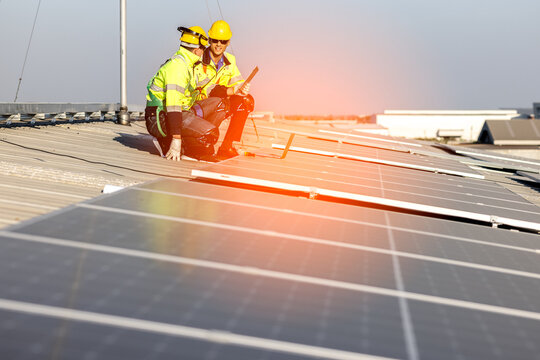 Green Energy, Professional Engineer Service Solar Panel. Worker Maintenance Cleaning Replacing Solar Panel. Solar photovoltaic panel system in Industry roof. Saving Energy with Clean Power. 