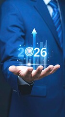 Businessman holds 2026 projected growth graphic