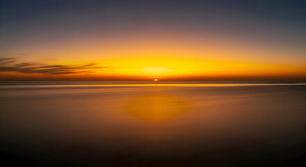 Sun setting over the ocean horizon