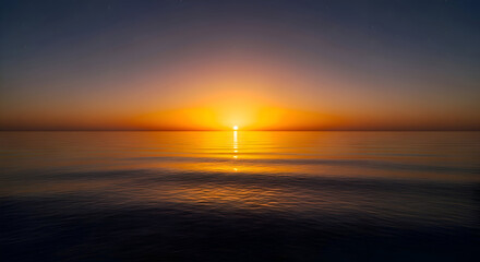 Sun Setting Over Calm Ocean Water at Dusk