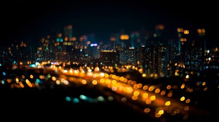 Obraz premium Vibrant cityscape at night with colorful illuminated buildings, abstract bokeh effect from out-of-focus lights,