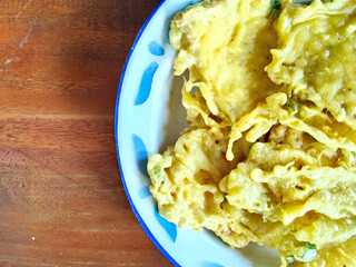 A Plate of Fried Tempe Mendoan with a Rice Field View
