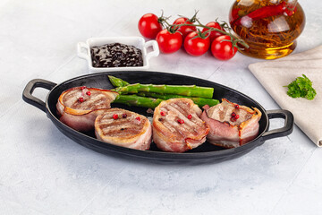 Tasty grilled pork medallion with bacon