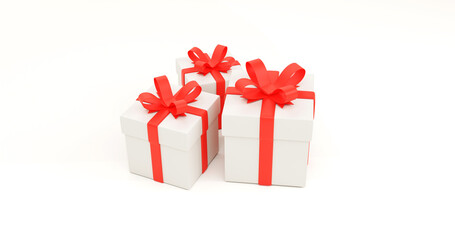 Three white gift boxes with red ribbon on clean background