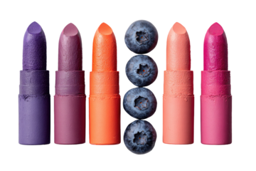 Colorful lipstick tubes in various shades of pink, purple, and orange, arranged in a horizontal row with fresh blueberries in the center