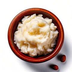 Creamy, pale-yellow food in a wooden bowl, with almonds