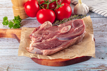 Raw lamb steak with bone