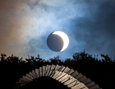 Partial solar eclipse over fan