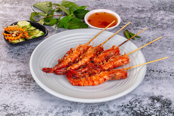 Grilled prawn skewer served sauce