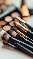 A collection of makeup brushes are displayed on a table