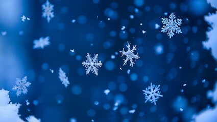 Snowflakes falling on dark blue background winter weather