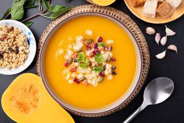 Top view of Butternut squash pumpkin soup with granola in a bowl, Homemade food in autumn season