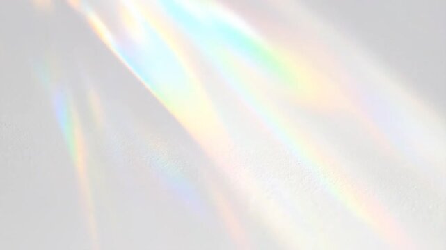 Light casts rainbow prism shadows on a neutral, textured surface