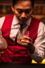 Bartender is pouring whiskey into a glass in a restaurant	