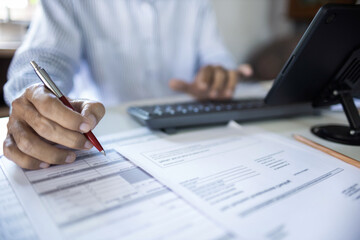 close up shot, asian businessman checking financial documents and business contract, working at home with tablet computer