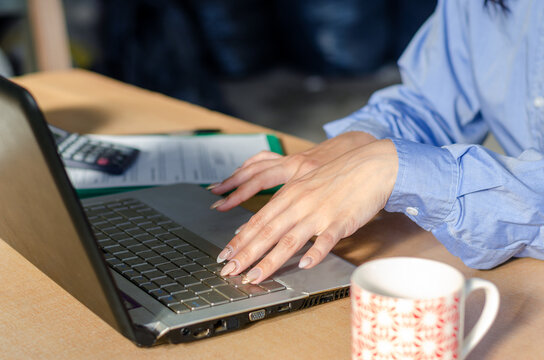 Portrait of woman hands using a laptop at office. - Powered by Adobe