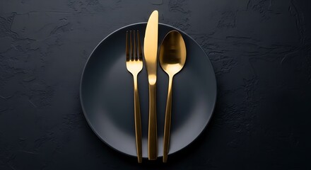 Gold Cutlery on Black Plate.