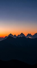 Fototapeta premium Sunrise Over Silhouettes of Majestic Mountains.