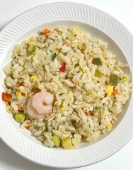 Nasi goreng, Indonesia's iconic fried rice dish, stir-fried with a blend of garlic, soy sauce, and spices. Often served with a fried egg, crispy crackers, and pickles, it's a flavorful and satisfying.