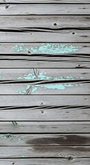 Horizontal weathered wooden planks display a muted gray tone with flecks of faded teal paint.