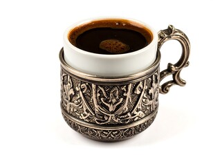 Ornate coffee cup filled with dark brew