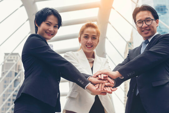 Diversity business partner people teamwork holding hands together power of tag team. Multiethnic Teamwork friendship group brainstorming togetherness. Business people team holding hands Solidarity. - Powered by Adobe