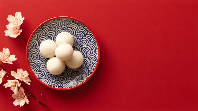 Tang Yuan sweet rice balls for Dongzhi and Lunar New Year on a red background Winter Solstice theme top view blank space
