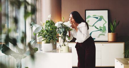 Woman, florist and smell with pot plant in office for eco friendly environment or natural growth. Female person, floral designer or aroma with scent for interior decor or sustainability in workplace