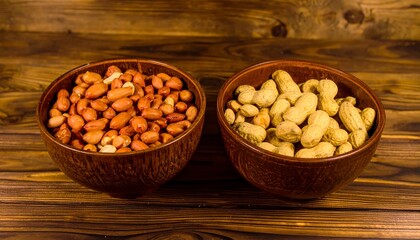 Two bowls of peanuts on a wooden table (1)
