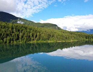 Fototapeta premium Serene lake reflecting a sky of clouds