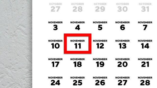 The date November 11th marked with a red cursor on the wall calendar 2025