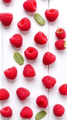 Fresh raspberries arranged artfully on a white surface